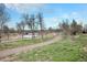 Community walking path with mature trees and a bridge at 2695 W Grand Ave, Littleton, CO 80123