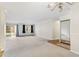 Large living room with carpet, large windows, sliding door access, and mirrored closet at 3082 S Wheeling Way # 106, Aurora, CO 80014