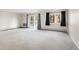 Spacious living room featuring neutral carpet, large windows with nice view, and a sliding glass door at 3082 S Wheeling Way # 106, Aurora, CO 80014