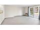 Bright living room with neutral carpet, large window, sliding glass door and view from the interior at 3082 S Wheeling Way # 106, Aurora, CO 80014