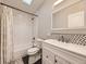 Updated bathroom with tub, shower, and white vanity at 846 S Sheridan Blvd, Denver, CO 80226