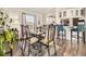 Elegant dining area adjacent to kitchen with glass table, chairs, and view of the backyard at 846 S Sheridan Blvd, Denver, CO 80226