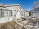 House exterior with light gray siding, white door, and a small patio at 846 S Sheridan Blvd, Denver, CO 80226