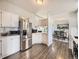 Bright kitchen boasts stainless steel appliances and white cabinetry, flowing into the dining area at 846 S Sheridan Blvd, Denver, CO 80226