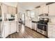 Kitchen with stainless steel appliances, white cabinets, and hardwood floors at 846 S Sheridan Blvd, Denver, CO 80226