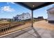View from covered back porch of neighborhood with open space and wood fence at 6882 Oak Canyon Cir, Castle Pines, CO 80108