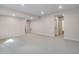 Finished basement with neutral carpet and paint. Bright recessed lighting at 6882 Oak Canyon Cir, Castle Pines, CO 80108