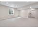 Spacious finished basement with neutral carpeting, egress window, and access to stairs at 6882 Oak Canyon Cir, Castle Pines, CO 80108