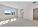 Bright, carpeted bedroom with large windows offering views of the neighborhood, perfect for relaxation and comfort at 6882 Oak Canyon Cir, Castle Pines, CO 80108