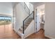 Contemporary entryway with light wood floors, metal railing staircase, and a view into a half bath at 6882 Oak Canyon Cir, Castle Pines, CO 80108