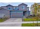 Charming two-story home with a blue-gray color scheme and a well-manicured front yard at 6882 Oak Canyon Cir, Castle Pines, CO 80108