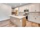 Open kitchen features a kitchen island, stainless steel appliances, and a modern design at 6882 Oak Canyon Cir, Castle Pines, CO 80108