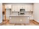 Bright kitchen boasts an island, stainless steel appliances, and elegant white cabinetry at 6882 Oak Canyon Cir, Castle Pines, CO 80108