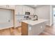 Stylish kitchen features a large island, stainless appliances, and chic white cabinets for ample storage at 6882 Oak Canyon Cir, Castle Pines, CO 80108