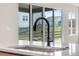 A close up of the kitchen sink and windows, revealing neighborhood views at 6882 Oak Canyon Cir, Castle Pines, CO 80108