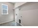 Laundry room with utility sink and storage shelf. Bright natural light at 6882 Oak Canyon Cir, Castle Pines, CO 80108