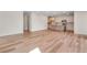 Open-concept living area with light wood floors, modern kitchen island, and ample space for entertaining and relaxing at 6882 Oak Canyon Cir, Castle Pines, CO 80108