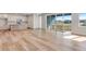 Bright, open-concept living area featuring light wood floors, modern cabinets, and a sliding glass door with an outdoor view at 6882 Oak Canyon Cir, Castle Pines, CO 80108