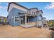 Blue two-story home with a covered patio and well-manicured backyard at 6882 Oak Canyon Cir, Castle Pines, CO 80108