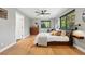 Bright bedroom featuring hardwood floors, a ceiling fan, and a window with outside view at 1801 Redwood Ave, Boulder, CO 80304
