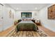 Comfortable bedroom with a quilted bedspread, a decorative rug, and soft lighting at 1801 Redwood Ave, Boulder, CO 80304