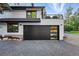 Charming two-story home with a dark garage door, landscaped yard, and a balcony at 1801 Redwood Ave, Boulder, CO 80304