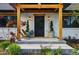 Inviting front porch with wood accents, decorative plants, and stylish outdoor seating for relaxation at 1801 Redwood Ave, Boulder, CO 80304