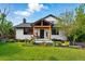 Charming two-story home with landscaped front yard and inviting covered porch with wooden beams at 1801 Redwood Ave, Boulder, CO 80304