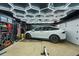 Organized garage featuring a car, storage solutions, and overhead lighting, perfect for car enthusiasts or hobbyists at 1801 Redwood Ave, Boulder, CO 80304
