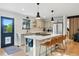 Modern kitchen with a large island, counter seating, stainless appliances, and lots of natural light at 1801 Redwood Ave, Boulder, CO 80304