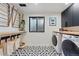 Well-organized laundry room featuring black and white patterned tile flooring, modern washer and dryer, and convenient drying rack at 1801 Redwood Ave, Boulder, CO 80304
