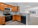 Updated kitchen, featuring stainless steel appliances and wood cabinetry at 3300 W Florida Ave # 77, Denver, CO 80219