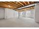 An unfinished basement offering potential for customization with exposed beams and structural support at 7040 Homeplace St, Castle Rock, CO 80108