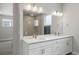 This bathroom features a double sink vanity and a spacious mirror enhancing the room's brightness at 7040 Homeplace St, Castle Rock, CO 80108