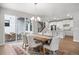 Bright dining room features sliding glass doors, stylish lighting, and a view of the modern kitchen at 7040 Homeplace St, Castle Rock, CO 80108