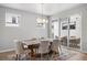 Bright dining room featuring a wood table, upholstered chairs, and sliding glass doors to the patio at 7040 Homeplace St, Castle Rock, CO 80108