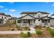 Attractive two-story home with stone accents, covered entry, and landscaped front yard featuring walkway and plants at 7040 Homeplace St, Castle Rock, CO 80108