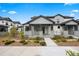 Charming two-story home featuring a covered porch with stone accents and well-maintained landscaping at 7040 Homeplace St, Castle Rock, CO 80108