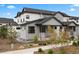 Beautiful two-story home with stone accents, covered entry, and landscaped front yard, offering modern elegance at 7040 Homeplace St, Castle Rock, CO 80108