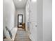 Cozy hallway with a bench, decorative pillow, runner rug, a mirror and views into other rooms at 7040 Homeplace St, Castle Rock, CO 80108