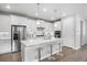 Modern kitchen boasting white cabinetry, a center island with seating, and stainless steel appliances at 7040 Homeplace St, Castle Rock, CO 80108