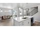 Open-concept kitchen with a center island, stainless steel appliances, and seamless access to the dining area at 7040 Homeplace St, Castle Rock, CO 80108