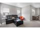 A comfortable living room with a plush leather couch, ottoman, and a small table with a dining area at 7040 Homeplace St, Castle Rock, CO 80108