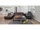Bright living room featuring an open layout, hardwood floors, and a seamless flow to the kitchen and dining spaces at 7040 Homeplace St, Castle Rock, CO 80108