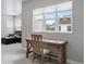 Bright office featuring a wooden desk, comfortable chair, and large window with a view of the neighborhood at 7040 Homeplace St, Castle Rock, CO 80108