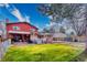 Expansive backyard featuring a patio area, well-kept lawn, hot tub, and manicured landscaping at 3035 S Biscay St, Aurora, CO 80013