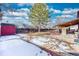 Large backyard with an entertainment area, privacy fence, and a storage shed at 3035 S Biscay St, Aurora, CO 80013