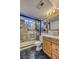 This bathroom features a shower, vanity, and toilet, with brown tile accents at 3035 S Biscay St, Aurora, CO 80013