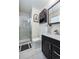 Updated bathroom featuring a glass shower door, black vanity, and contemporary fixtures at 3035 S Biscay St, Aurora, CO 80013