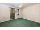 This bedroom has a ceiling fan, window, neutral colored walls, and green carpets at 3035 S Biscay St, Aurora, CO 80013